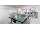 Basement rec room includes a bar, ping pong table, and comfortable seating creating an ideal space for Gathering enjoyment at 8107 Arapahoe Peak St, Littleton, CO 80125