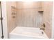 This bathroom features a soaking tub with tiled walls at 8107 Arapahoe Peak St, Littleton, CO 80125