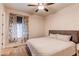 Cozy bedroom showcasing a comfortable bed, a ceiling fan, and natural light streaming through the window at 8107 Arapahoe Peak St, Littleton, CO 80125