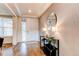 Elegant entryway features wood floors, textured wallpaper, and stylish decor for a welcoming ambiance at 8107 Arapahoe Peak St, Littleton, CO 80125