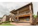 Exterior view of multi-level deck and stairs leading down to landscaped yard at 8107 Arapahoe Peak St, Littleton, CO 80125