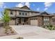 Charming two-story home features a two-car garage, stone accents, and a well-manicured front yard at 8107 Arapahoe Peak St, Littleton, CO 80125