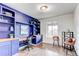 Inviting home office with custom built-ins, wood desktop, and large window at 8107 Arapahoe Peak St, Littleton, CO 80125