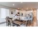 Modern kitchen with white cabinets, stainless steel appliances, and a large island with seating for entertaining at 8107 Arapahoe Peak St, Littleton, CO 80125
