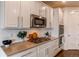 Well-appointed kitchen showcasing white cabinets, stainless steel appliances, and a modern gas cooktop at 8107 Arapahoe Peak St, Littleton, CO 80125