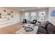 Bright and sunny living room with comfortable seating and lots of natural light at 8107 Arapahoe Peak St, Littleton, CO 80125