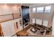 Cozy second floor living room with a fireplace, large windows, and a comfortable sectional sofa at 8107 Arapahoe Peak St, Littleton, CO 80125