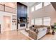 Bright, spacious living room with high ceilings, fireplace, large TV, and stylish contemporary decor at 8107 Arapahoe Peak St, Littleton, CO 80125