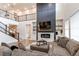 Spacious living room features a fireplace, built-ins, second story overlook, and cozy seating area at 8107 Arapahoe Peak St, Littleton, CO 80125