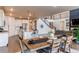 Open concept living area with kitchen, dining, and living room with a staircase leading to the second level at 8107 Arapahoe Peak St, Littleton, CO 80125