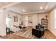 Bright living room includes modern furniture, white trim, tray ceiling, and an adjacent butler's pantry at 8107 Arapahoe Peak St, Littleton, CO 80125