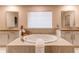 A large soaking tub with double vanity and a window sits in this main bathroom at 8107 Arapahoe Peak St, Littleton, CO 80125