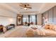 The main bedroom is large with a seating area, large windows, and ceiling fan at 8107 Arapahoe Peak St, Littleton, CO 80125