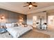 Bright main bedroom boasts a tray ceiling, accent wall, and ensuite bathroom access at 8107 Arapahoe Peak St, Littleton, CO 80125