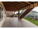 Lower level patio with stone pavers and wood beam deck structure overhead at 8107 Arapahoe Peak St, Littleton, CO 80125