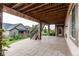 Lower level patio with stone pavers, access to yard, and deck overhead at 8107 Arapahoe Peak St, Littleton, CO 80125