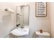 Charming powder room featuring a pedestal sink, toilet, and decorative accents at 8107 Arapahoe Peak St, Littleton, CO 80125