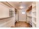 A walk-in closet provides plenty of storage with built-in shelving and dual benches at 8107 Arapahoe Peak St, Littleton, CO 80125