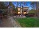 This home features an outdoor seating area with fire pit, wooden deck, and lush yard at 510 Castle Pines Dr, Castle Rock, CO 80108