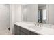 Bathroom vanity with a quartz countertop, modern faucet, and a large mirror at 510 Castle Pines Dr, Castle Rock, CO 80108