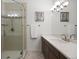 Bathroom features tile shower with glass door, dual vanity with white countertop and modern lighting at 510 Castle Pines Dr, Castle Rock, CO 80108