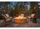 Outdoor seating area with a stone fire pit surrounded by comfortable chairs, perfect for enjoying evenings outdoors at 510 Castle Pines Dr, Castle Rock, CO 80108