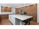 A spacious kitchen features custom wood cabinets, stainless steel appliances, and a large white center island at 510 Castle Pines Dr, Castle Rock, CO 80108
