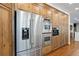 Kitchen boasts stainless steel refrigerator, double ovens, and abundant wooden storage cabinets at 510 Castle Pines Dr, Castle Rock, CO 80108