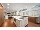 Open kitchen features a large island, stainless steel appliances, skylight, and abundant wood cabinetry at 510 Castle Pines Dr, Castle Rock, CO 80108