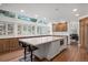 Spacious kitchen with skylights, custom wood cabinetry, a large center island, and hardwood flooring throughout at 510 Castle Pines Dr, Castle Rock, CO 80108