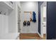 Mudroom with bench, storage, coat hooks, backpack hangers, and hardwood floors near a blue painted wall at 510 Castle Pines Dr, Castle Rock, CO 80108