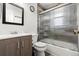 Bathroom featuring a modern vanity, stylish mirror, and a bathtub with glass doors at 741 Cortez St, Denver, CO 80221