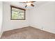 Bright bedroom with plush carpet flooring, a ceiling fan, and a window letting in natural light at 741 Cortez St, Denver, CO 80221