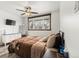 Comfortable bedroom featuring a ceiling fan, dresser, and a window for natural light at 741 Cortez St, Denver, CO 80221