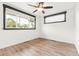Bright Bedroom features a ceiling fan, hardwood flooring, and large windows with black trim at 741 Cortez St, Denver, CO 80221