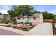 Charming home with solar panels, a well-kept yard, and a pop of color on the front door at 741 Cortez St, Denver, CO 80221