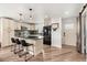 Open kitchen with an island, modern appliances, stylish pendant lights, and updated flooring at 741 Cortez St, Denver, CO 80221