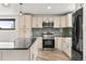 The kitchen features white cabinets, granite countertops, and stainless steel appliances at 741 Cortez St, Denver, CO 80221