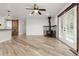 Living Room with a ceiling fan, wood burning stove, and hardwood flooring at 741 Cortez St, Denver, CO 80221