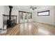 Living Room with a ceiling fan, wood burning stove, and hardwood flooring at 741 Cortez St, Denver, CO 80221