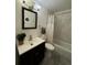 Clean and well-lit bathroom with tile shower, modern vanity, and neutral color scheme at 10702 E Exposition Ave # 101, Aurora, CO 80012