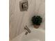 Clean and well-lit bathtub and faucet with tile surround and modern fixtures at 10702 E Exposition Ave # 101, Aurora, CO 80012