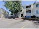 Exterior view of the condo complex featuring well maintained siding, private balconies, and clearly marked unit numbers at 10702 E Exposition Ave # 101, Aurora, CO 80012