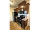 Well-lit kitchen with stainless steel appliances, gas range, granite counters, and wood cabinets at 10702 E Exposition Ave # 101, Aurora, CO 80012