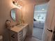 Bathroom view featuring a modern vanity, stylish mirror, and open doorway to a bedroom at 14433 E Jewell Ave # 101, Aurora, CO 80012