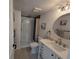 Updated bathroom features a shower, modern vanity with a round mirror and stylish lighting fixtures at 14433 E Jewell Ave # 101, Aurora, CO 80012