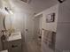 Contemporary bathroom with a modern vanity, round mirror, decorative accents, and tiled floors at 14433 E Jewell Ave # 101, Aurora, CO 80012