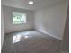 Spacious bedroom featuring a large window, neutral walls, and plush carpet flooring at 14433 E Jewell Ave # 101, Aurora, CO 80012