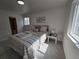 Bright bedroom featuring carpet, a window, and a comfortable bed with decorative pillows and artwork at 14433 E Jewell Ave # 101, Aurora, CO 80012
