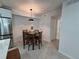 Cozy dining area features a wooden table set with four chairs and modern lighting fixtures at 14433 E Jewell Ave # 101, Aurora, CO 80012